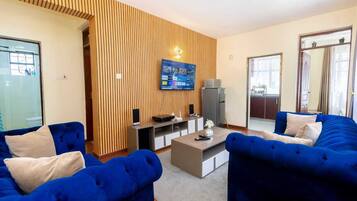 Deluxe Apartment | Living area | 24-inch Smart TV with digital channels