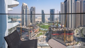 A high-rise building with a view of a cityscape, including several tall buildings and a construction site.