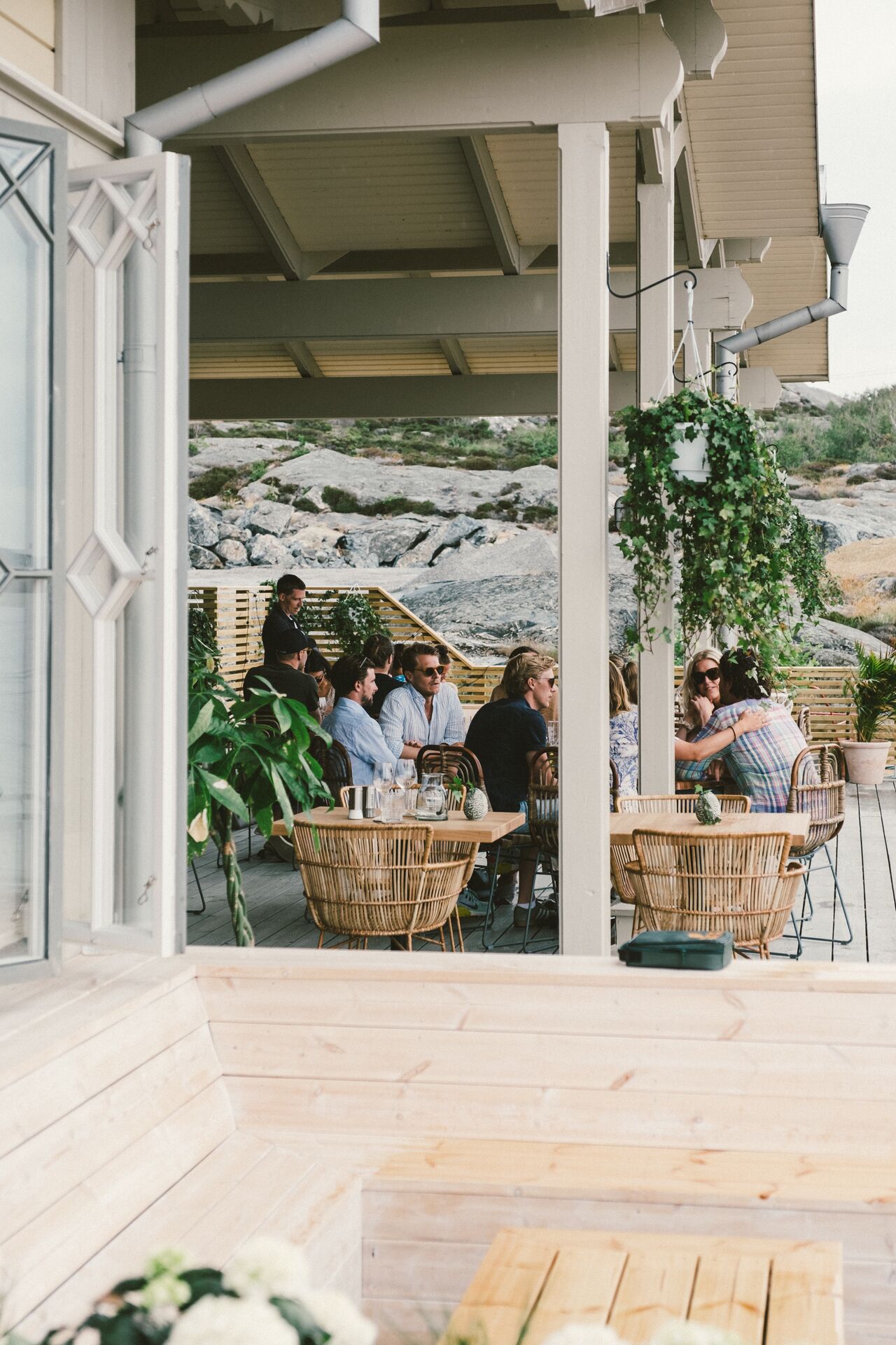 An outdoor seating area with wicker furniture and a view of rocky terrain.