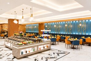 A modern hotel lobby with a central buffet, seating area, and a decorative wall with vertical lines. - Hometel Alambagh Lucknow  (Lucknow)