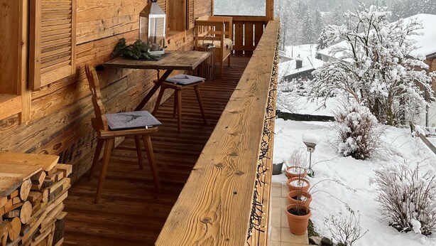 A wooden cabin with a balcony overlooking a snowy landscape. - Bergchalet Four Seasons (Reit im Winkl)