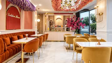 A restaurant with a red archway, a bar area, and a seating arrangement with tables and chairs.