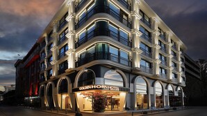 A multi-story hotel with a classic architectural design, featuring balconies and large windows. - Golden Horn Bosphorus Hotel  (Istanbul)