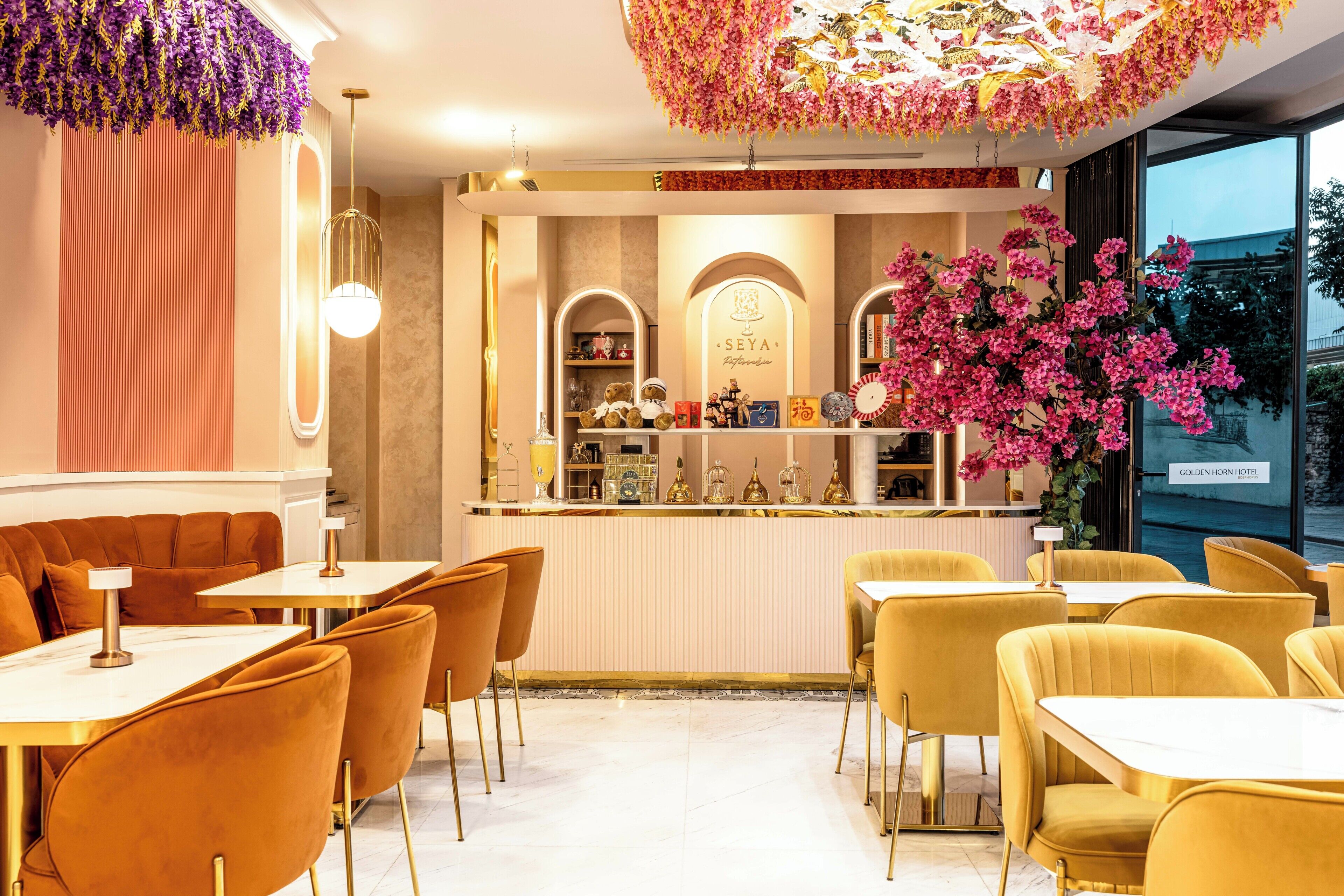 A restaurant interior with a bar area, seating arrangements, and a decorative ceiling.