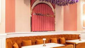 A restaurant interior with a red archway, a booth seating area, and a table with a lamp. - Golden Horn Bosphorus Hotel  (Istanbul)