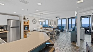 A spacious kitchen with a large island, modern appliances, and a view of the ocean. - Phoenix 8 903 | Indoor, Outdoor Pools | Beachfront | Tennis | My Beach Getaways (Orange Beach)