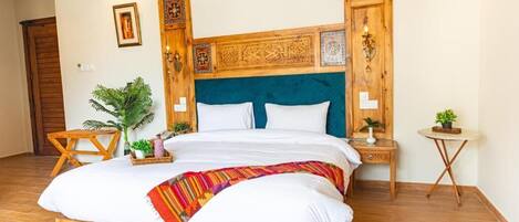 A bedroom with a wooden bed, a blue upholstered headboard, and decorative wall panels.