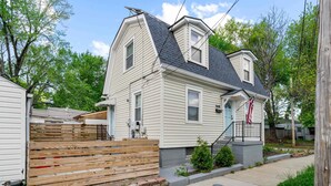 A two-story house with a gabled roof, a front porch, and a small front yard. - Relaxing historic home close to Churchill Downs! (Louisville)