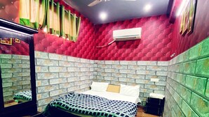 A bedroom with a bed, a desk, a chair, a ceiling fan, and a TV. - Manali Hotel By GRB (New Delhi)