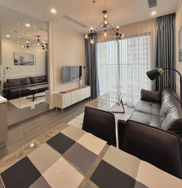 Deluxe Apartment | Living area | 50-inch Smart TV with digital channels - NVT Housing - Vinhomes Ocean Park Apartment Hanoi (Hanoi)