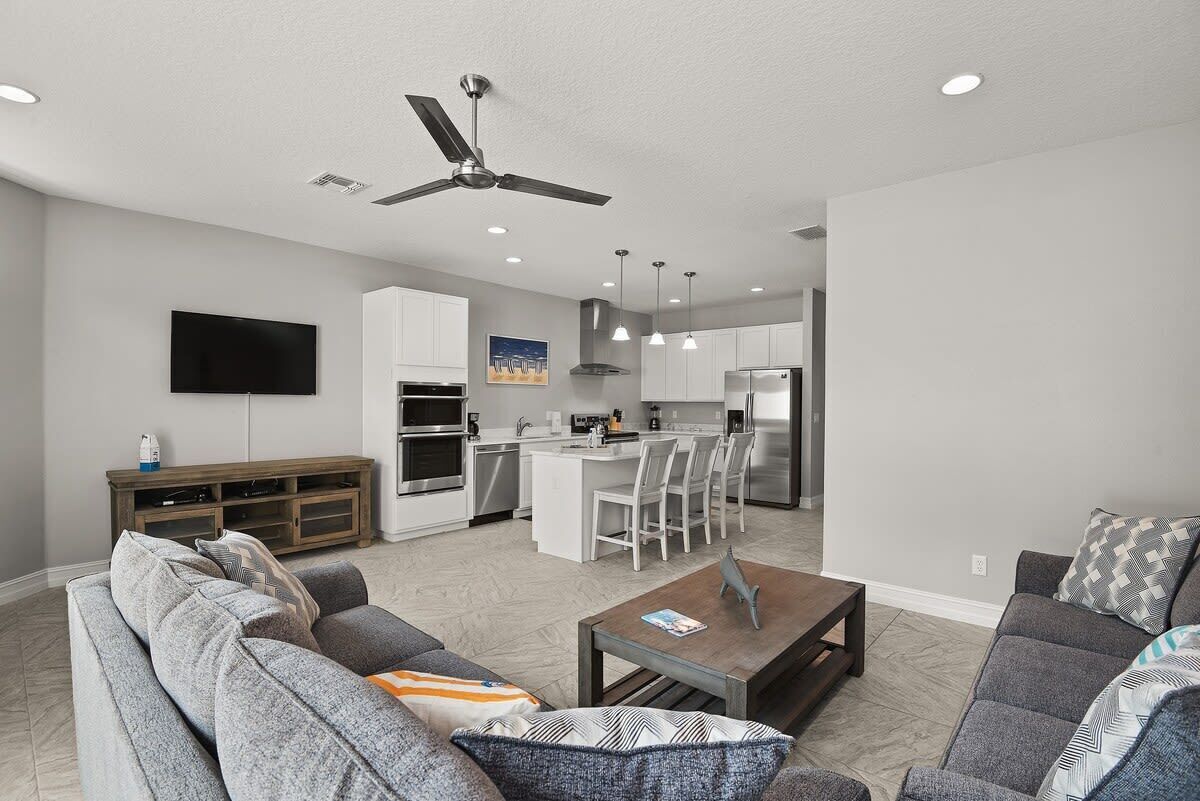 A modern living room with a sofa, coffee table, and a TV.