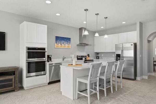 Enjoy cooking in this well-equipped kitchen with a central island, oven, and microwave.