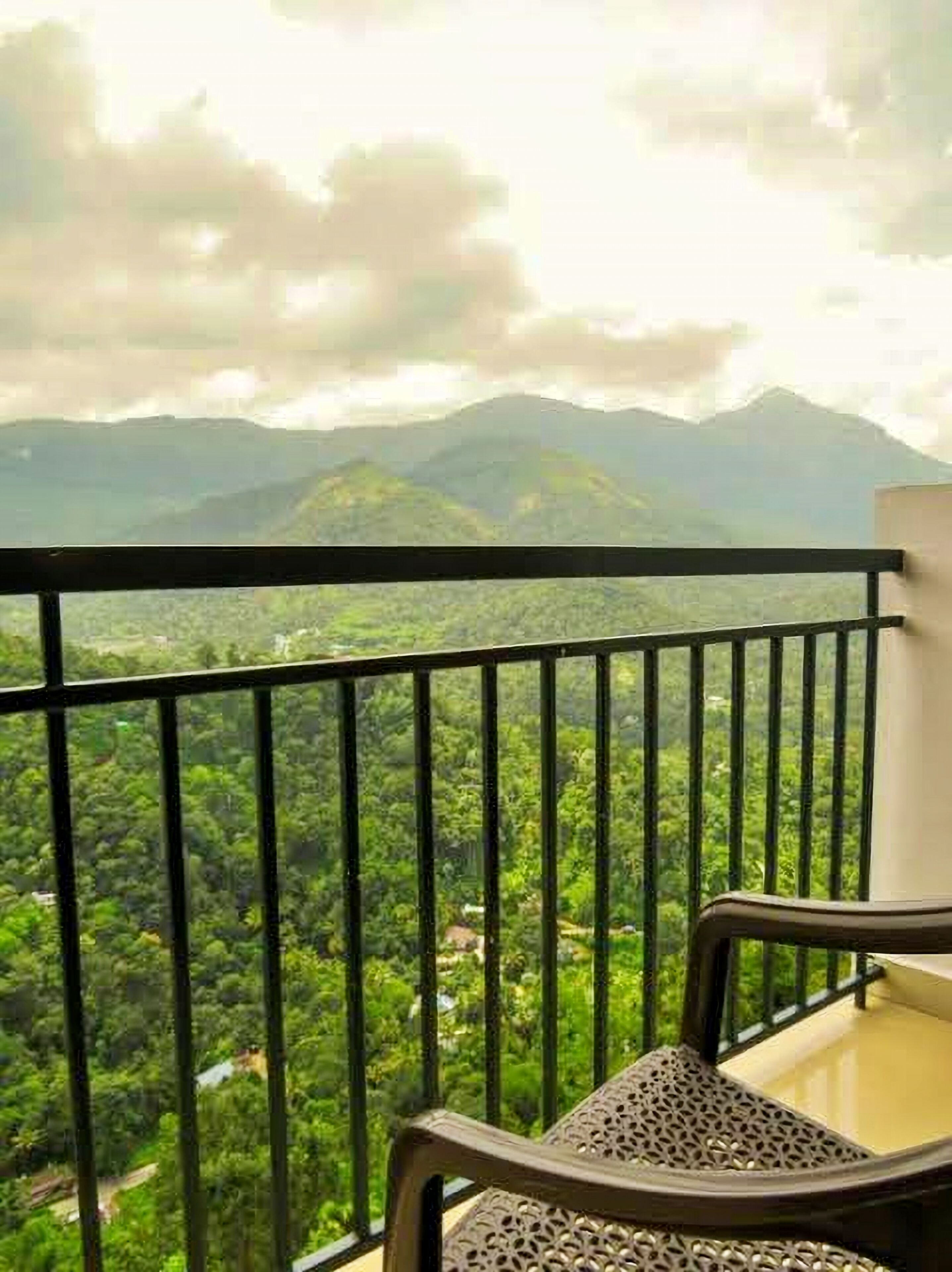 A balcony with a view of a mountainous landscape.