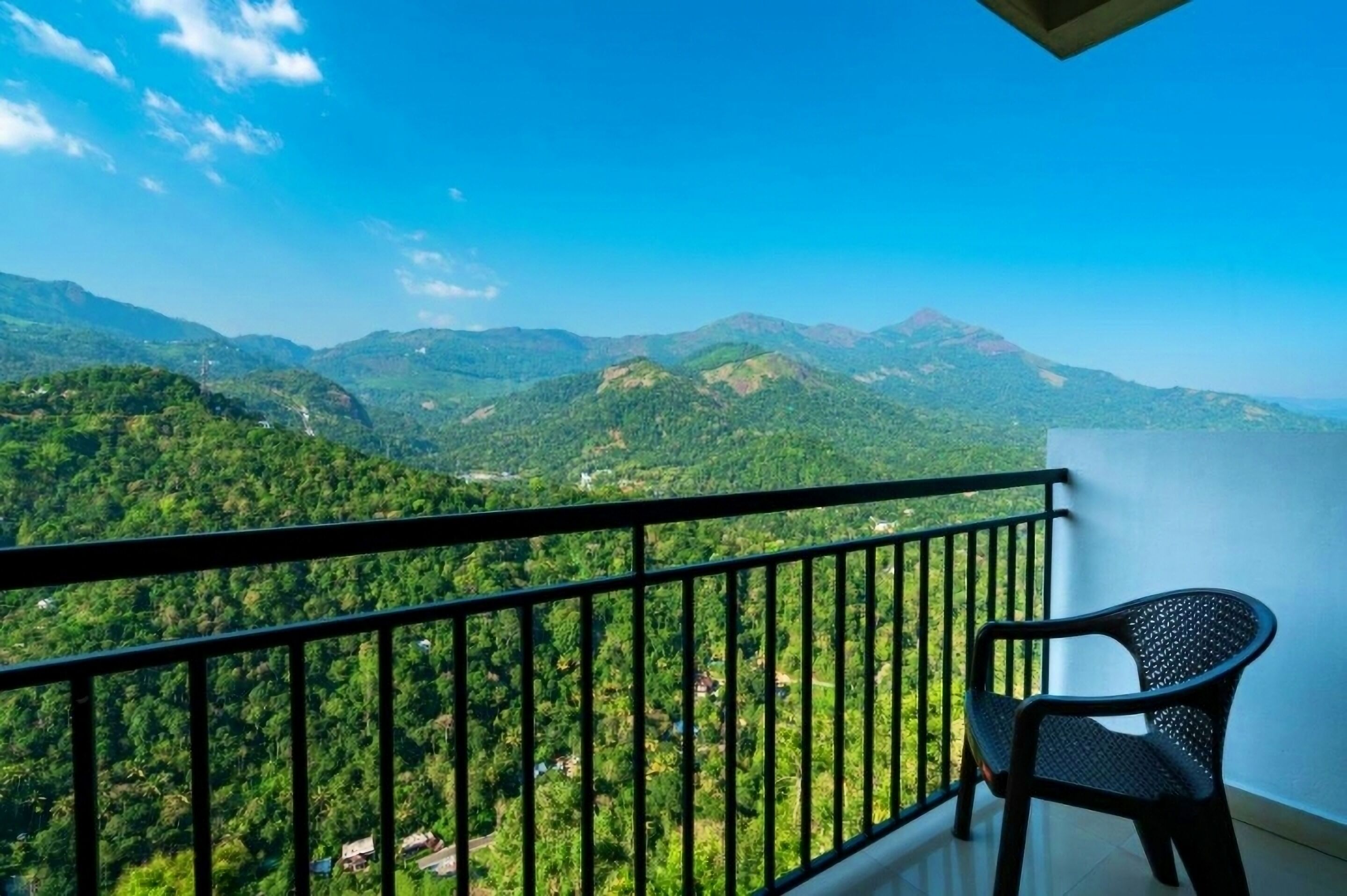 A balcony with a view of a mountainous landscape.