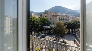 A balcony with a view of a town square, buildings, and a mountain. - Charming House in Cefal by Wonderful Italy (Cefalù)