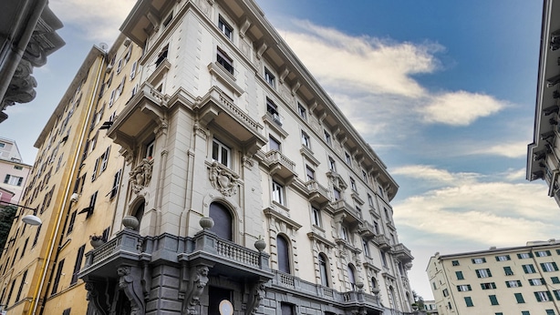 A multi-story building with classical architecture, featuring ornate balconies and large windows. - Loft Garibaldi by Wonderful Italy (Genoa)
