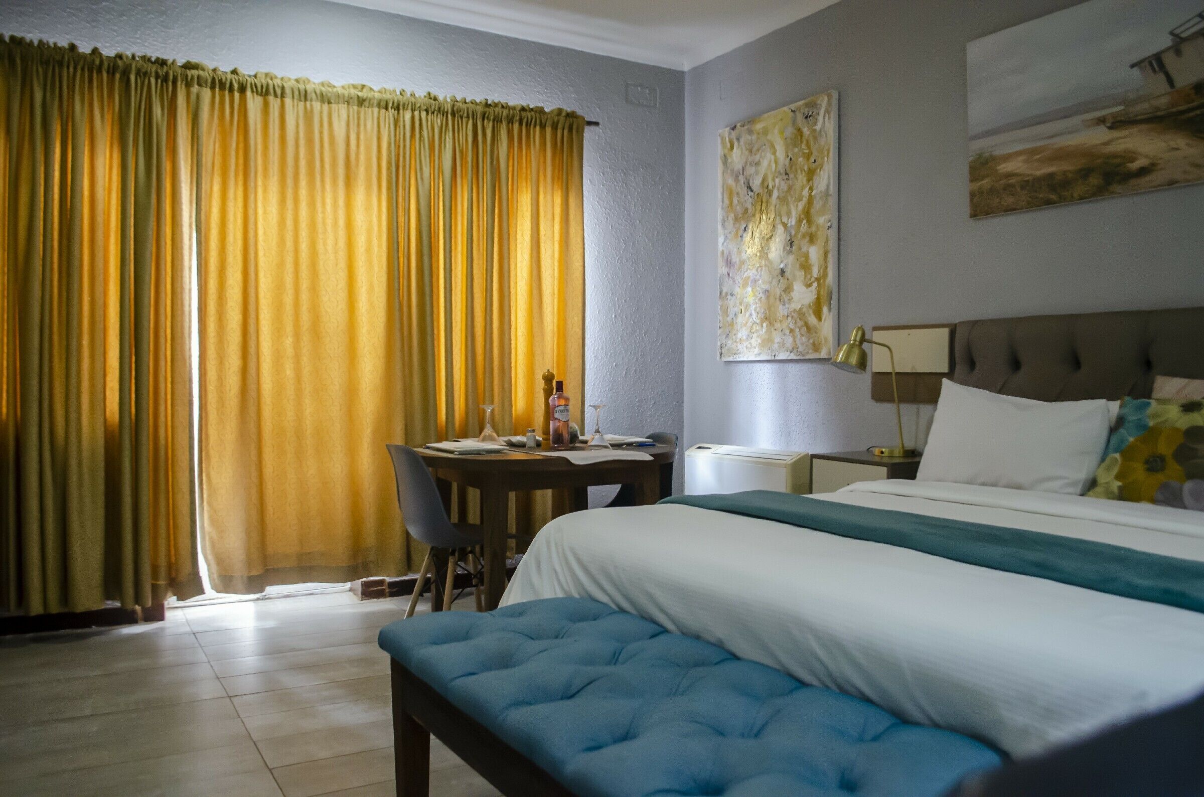 A hotel room with a bed, a desk, and a chair.