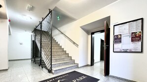 En trappa som leder upp till en lägenhetsvåning, och vid ingången ligger en dörrmatta med texten ”CENTRUM PARK”.