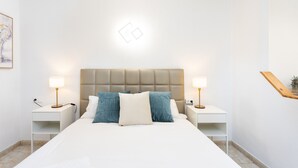 A neatly arranged bedroom with a large bed, two bedside tables, and a headboard. - COSTA ADEJE BEACH & SUN 2 (Costa Adeje)