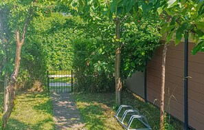 Stroll through lush gardens to a serene entrance.