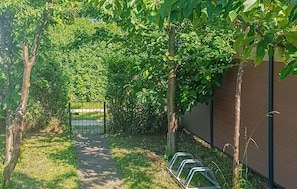Stroll through lush gardens to a serene entrance.