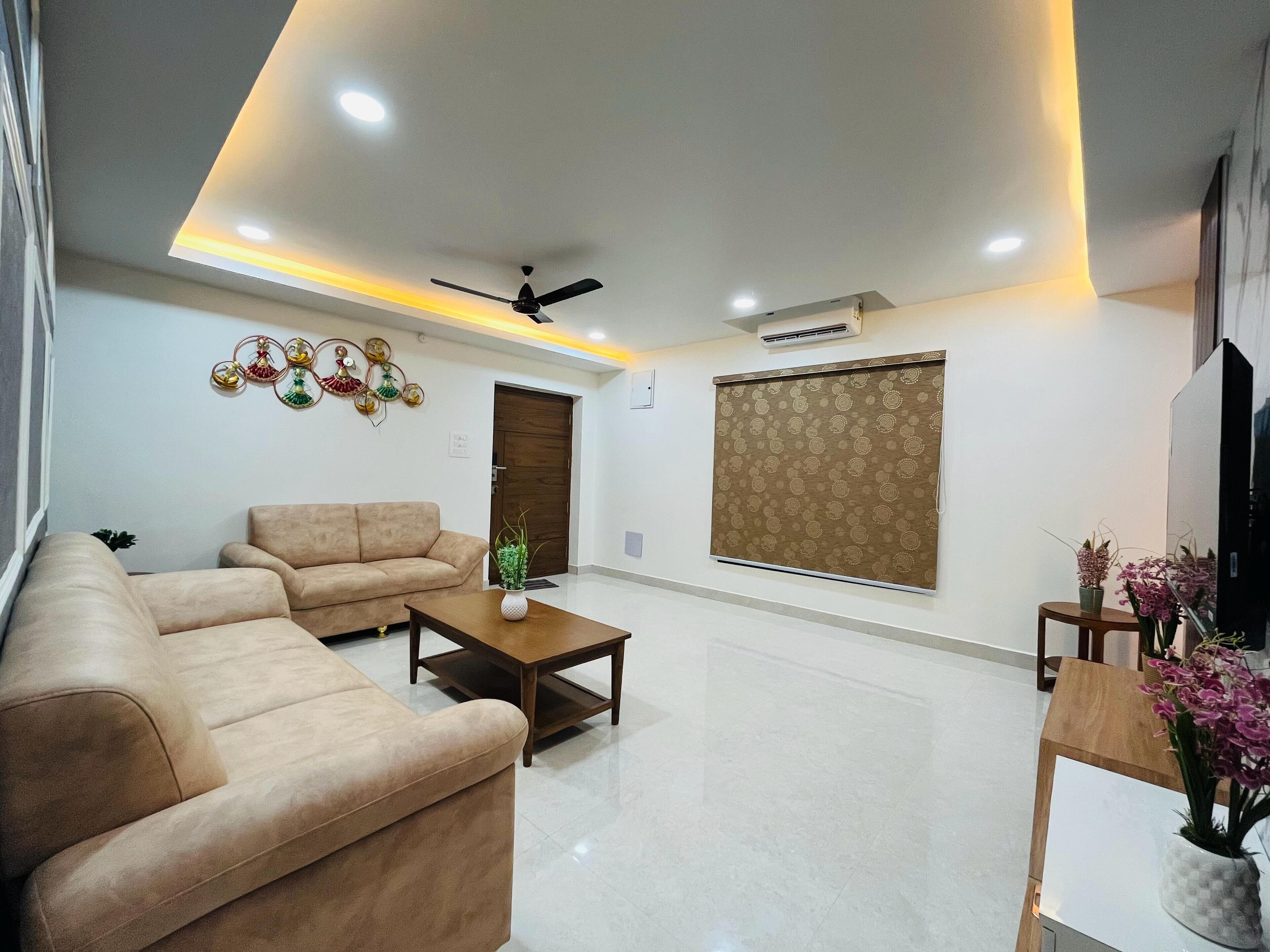 A modern living room with a sofa, coffee table, and decorative wall pieces.