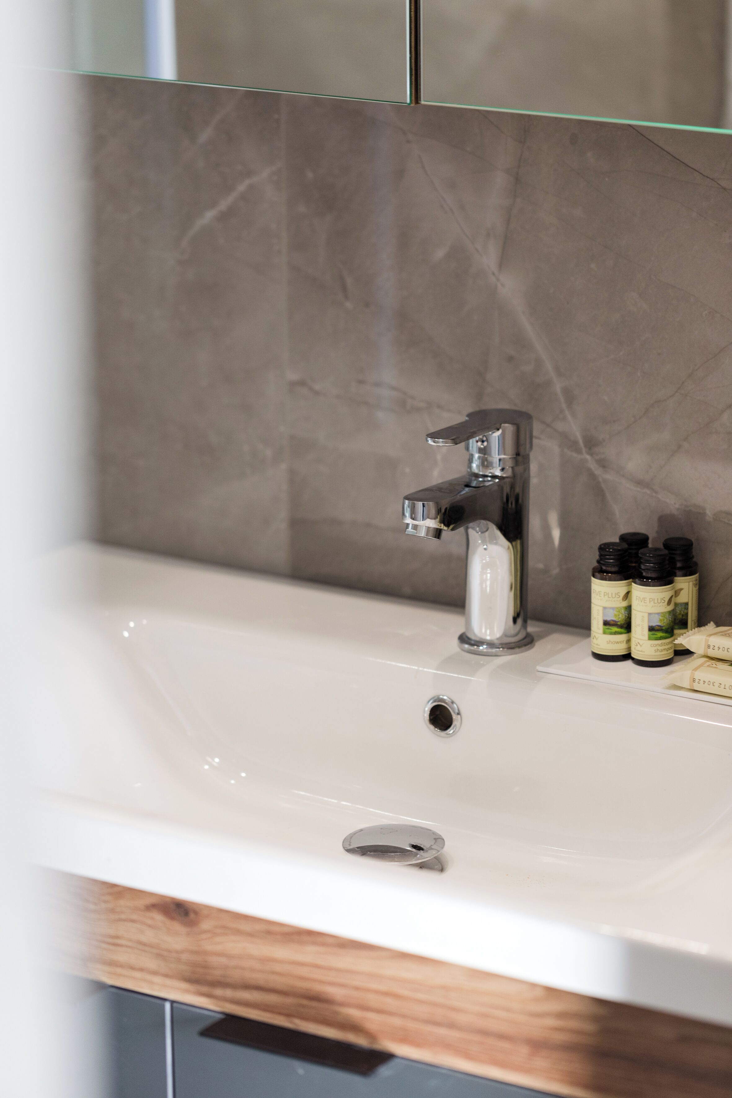 A bathroom sink with a modern faucet and a mirror above it.