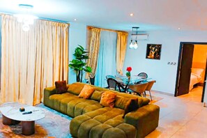 Deluxe Apartment, 2 Bedrooms | Living area | 55-inch flat-screen TV with satellite channels, TV, Netflix - Signature Hotel Apartment Accra Ghana (Accra)