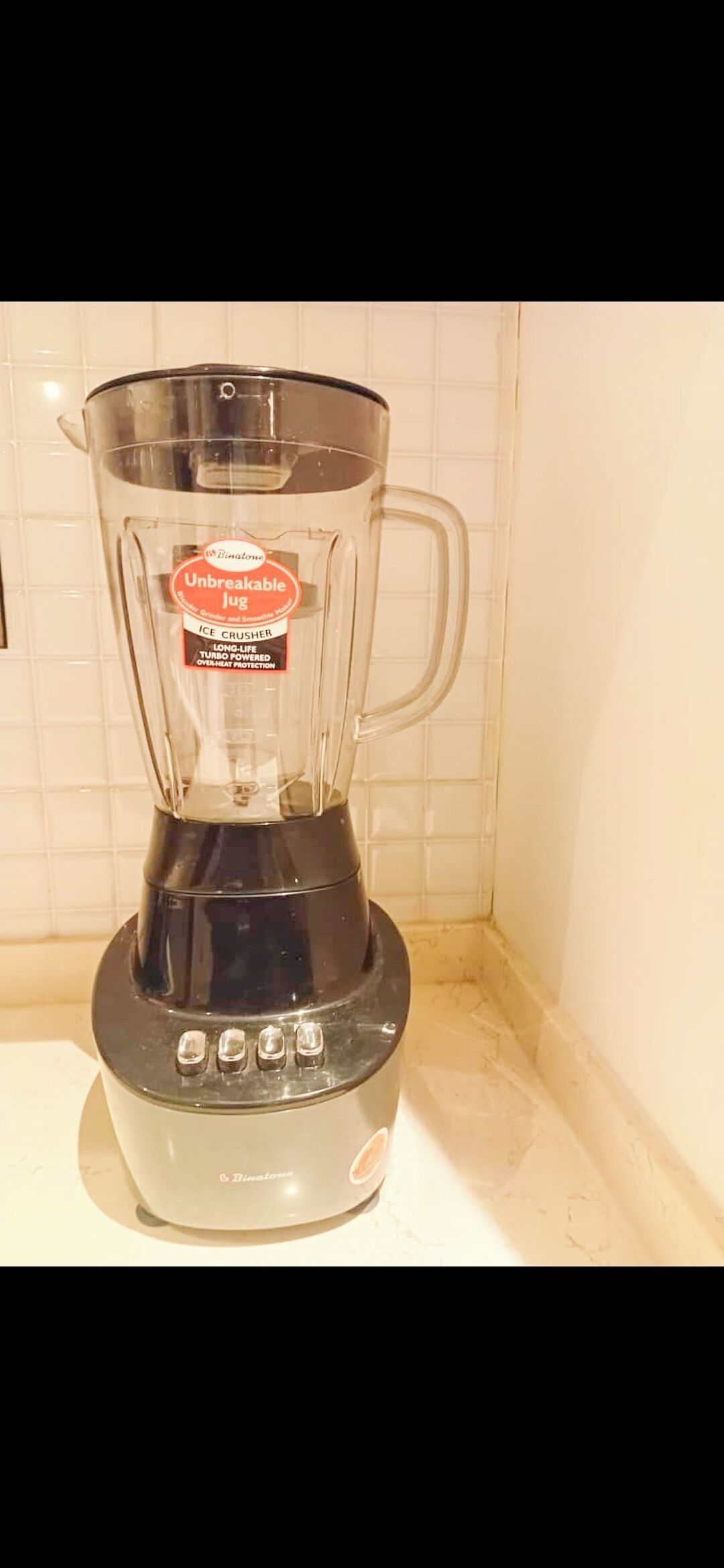 A kitchen with a blender on the counter.