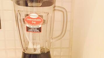A kitchen with a blender on the counter.
