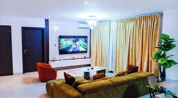 Deluxe Apartment, 2 Bedrooms | Living area | 55-inch flat-screen TV with satellite channels, TV, Netflix