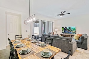 Lavish Dining Area of the Townhouse in Kissimmee Florida - 8 Persons Dining - Chic dining area featuring a stylish table and contemporary seating - Chic dining area with a statement pendant lighting - Disney Themes: Resort 5BR Townhouse w Private Pool (Kissimmee)
