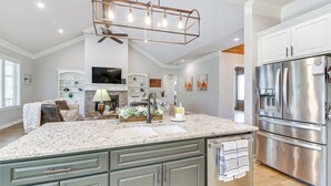 A spacious kitchen with a large island, stainless steel appliances, and a modern chandelier. - Spacious Hot Springs Village Home < 1 Mi to Lake! (Hot Springs Village)