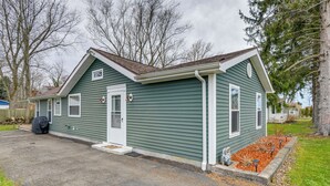 A single-story house with a gabled roof, a front door, and a small porch area. - Angola Getaway: Walk to Lake Erie Beach Park! (Angola)