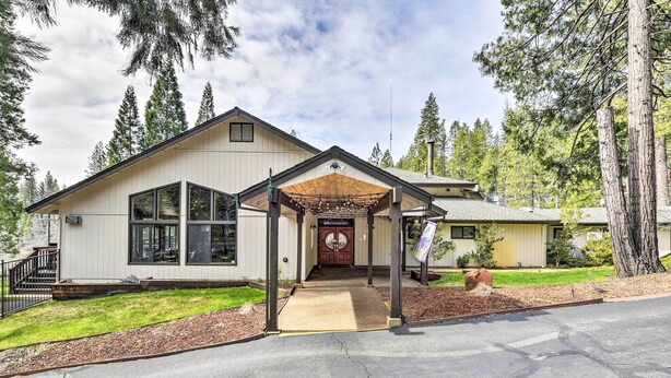 A two-story house with a covered porch, large windows, and a well-maintained lawn. - Game Room + Pool Access: Spacious Cabin in Arnold (Arnold)