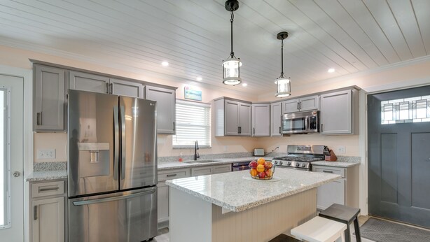 A modern kitchen with stainless steel appliances, a granite countertop, and pendant lighting. - Angola Vacation Rental, Walk to Lake Erie Beach! (Angola)