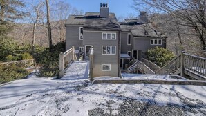 A two-story house with a front porch, a staircase, and a driveway. - Cozy Mountain Retreat w/ Balcony Views & Fireplace (Sugar Mountain)
