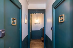 Enter a stylish hallway with a two-tone color scheme, leading to a welcoming door.