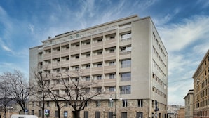 A multi-story building with a flat facade, numerous windows, and balconies. - Carignano Luxury Suite by Wonderful Italy (Genova)