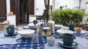 A table set with various bowls, cups, and a coffee pot, indicating a dining area. - House Garden San Lorenzo (Salerno)