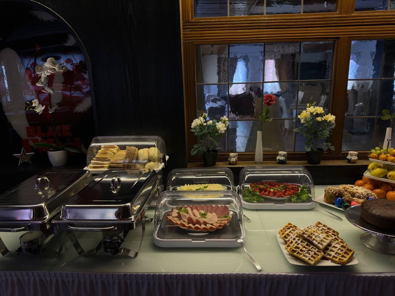 A buffet with various food items including sandwiches, salads, and desserts.