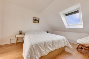 Cozy retreat with a single bed, bedside table, and window for natural light.
