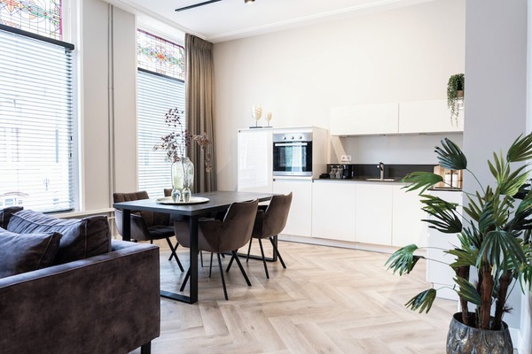 Spacious open-plan living area with modern kitchen and stylish decor, offering a bright and welcoming atmosphere perfect for relaxation or entertaining.