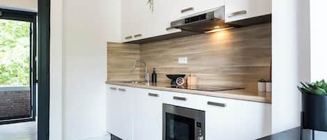 Fridge, stovetop, dishwasher, coffee/tea maker