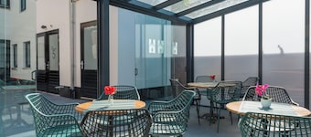 Wake up in the heart of Tilburg in a cozy hotel bed that blends past charm with modern comfort