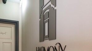 En hall med en skylt som visar ordet ”HARMONI” och en dörr med texten ”Frukost”.