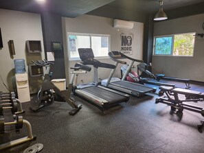 A gym with treadmills, a stationary bike, and weightlifting equipment. - Penthouse Ejecutivo Santo Domingo  (Santo Domingo)