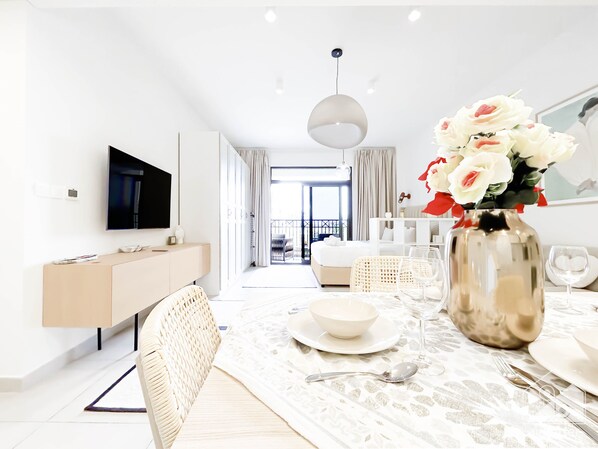Relax in style with a flat-screen TV, comfortable sofa, and dining area overlooking the city.