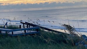 A wooden pier extending into the ocean with waves crashing nearby. - Stunning Oceanfront Home with Private Beach Access - 468 Tarpon (Fripp Island)