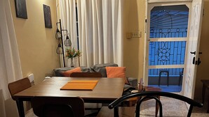 A dining area with a wooden table, chairs, and a decorative centerpiece. - Prime Negril Location - 2br brand new apartment. New Water tank installed. (Negril)